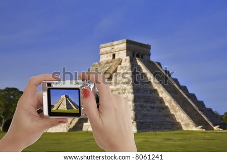 Caucasian female taking a picture of Chichen Itza  The main pyramid El Castillo is also called Temple of Kukulcan.