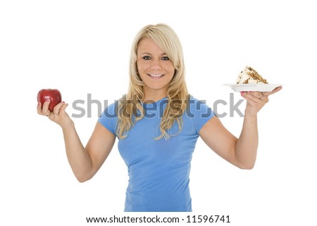 Caucasian woman holding an apple and slice of cake trying to decide which one to eat