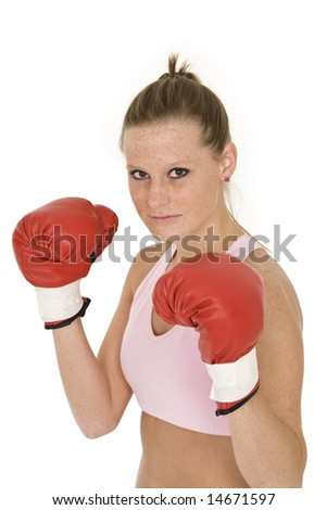 Young Caucasian woman in red boxing gloves getting ready to fight