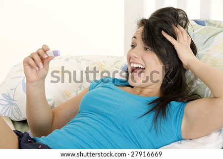 Young Caucasian woman looking at pregnancy test
