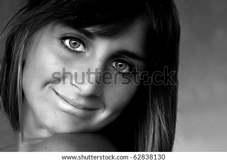 Portrait of young woman smiling, studio portrait. Young woman smiling, studio portrait, black white