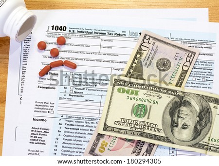 Federal tax form with aspirins sad face