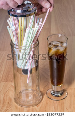 Removing a straw to add to a cold drink