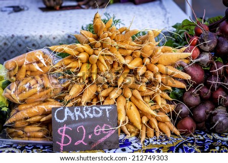 Orange carrots and sign showing the cost
