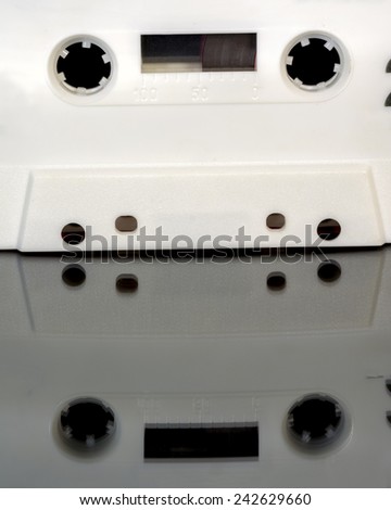 Old white cassette tape in a plastic case