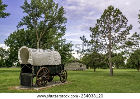 Rustic covered wagon and a park