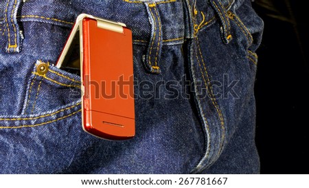 Dumb phone in the front pocket of jeans