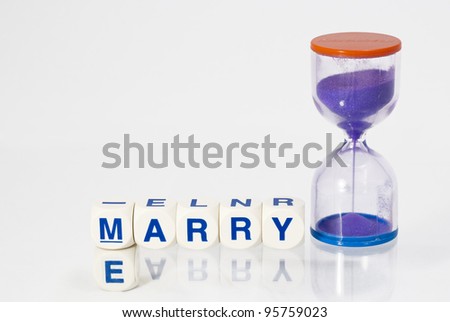Spelled out Marry Me with an hour glass timer signifying time is running out.