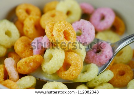 Fruit loop cereal rings for breakfast with milk closeup