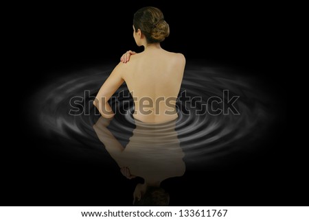 women naked back goes in the water in the dark night