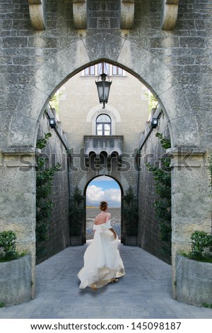 young bride woman runs out of a medieval castle on a beautiful landscape
