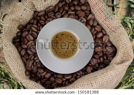 Sack of coffee beans and a cup of coffee vintage