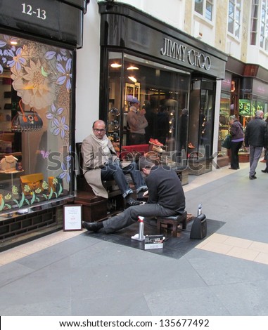 APRIL 10: Shoe shine man outside londons famous Burlington arcade