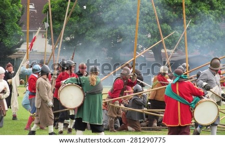 LONDON- MAY 25: Crowds attend a english civil war re-enactment, at valence park, dagenham, to celebrate the 50th year of barking and dagenham, becoming a london borough. LONDON, MAY 25, 2015.