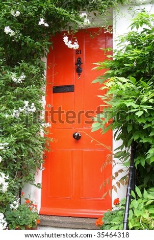Red front door and flowers.