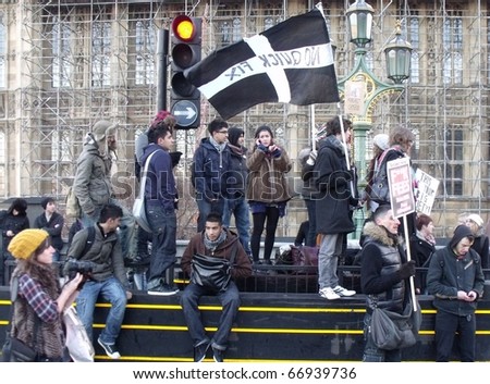 LONDON - DEC 9: Students demonstration against university fee rises in front of police lines at the houses of parliament buildings London, dec 9, 2010.
