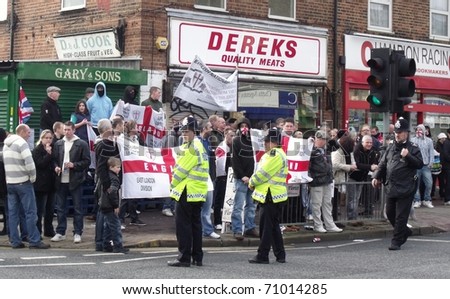 LONDON - FEB 12: English defence league protesters demonstrate behind police lines, against londons latest mosque being built at Dagenham, london, feb 12, 2011.