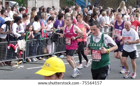 LONDON - APRIL 17: Crowds cheering the virgin 2011 London marathon runners, at tower bridge, London, April 17, 2011.