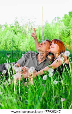men and women smiles stay on the grass outdoor