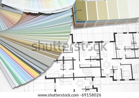 Architect\'s and Designer\'s desk during work. With technical drawing and color sample catalog.
