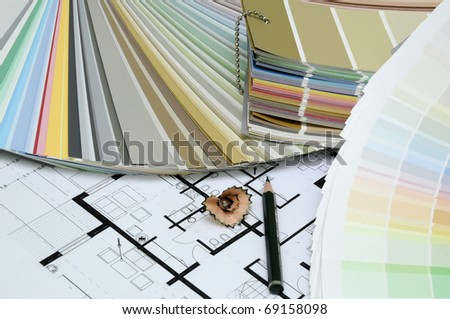 Architect\'s and Designer\'s desk during work. With technical drawing, color sample catalog and pencils.