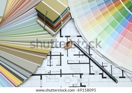 Architect\'s and Designer\'s desk during work. With technical drawing, color sample catalog and pencils.