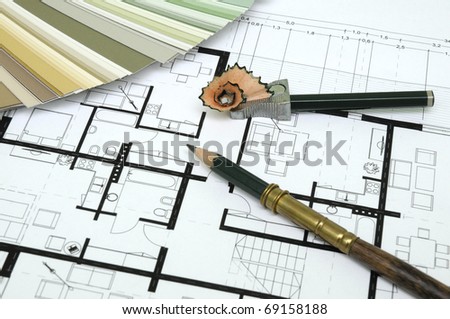 Architect\'s and Designer\'s desk during work. With technical drawing, color sample catalog, pencils, and other tools.