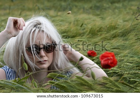 An attractive blonde lady in a corn field