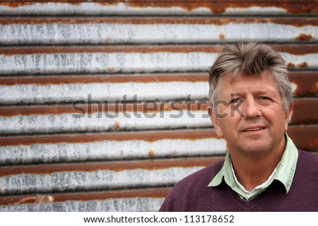 Mature man portrait with a rusty tin background