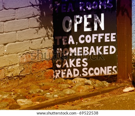 Tea shop sign leaning against an outside wall