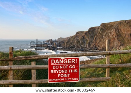 Sign warning of danger at cliff edge