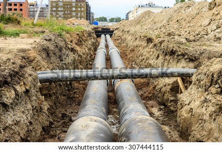 Laying of heating pipeline in the trench to provide new houses with hot water