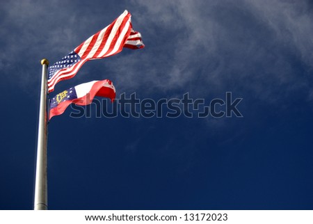 The US and Georgia flags hanging from the same flagpole