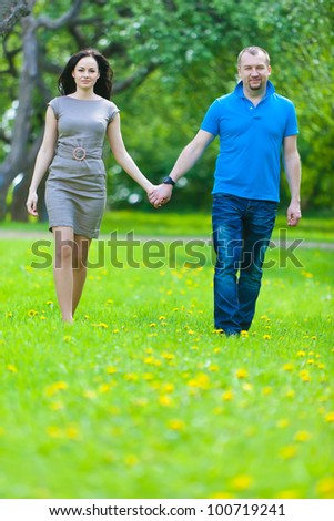 Couple in love in the spring blossoming apple orchard