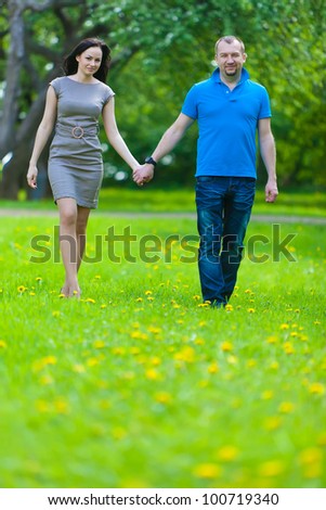 Couple in love in the spring blossoming apple orchard