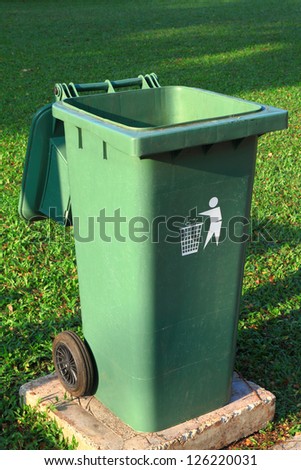 Green plastic trash recycling container in the park