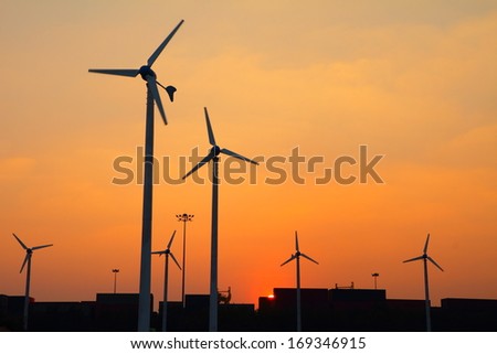 Clean energy wind turbine silhouettes at sunset, at Thailand