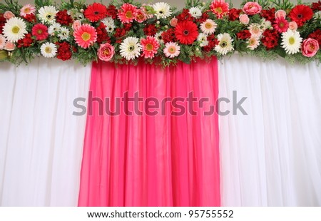 Exotic flowers arrangement over pink and white fabric, flowers background.