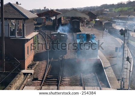 Smoke and steam from two passing antique rail engines