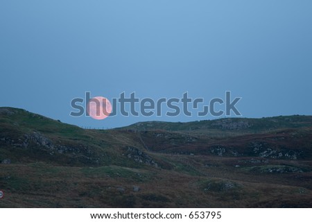 Moonrise over the Isle of Lewis, Scotland, photographed with a long lens