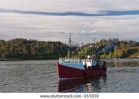 A fishing boat returns to Stornoway Harbour, Isle of Lewis, Scotland