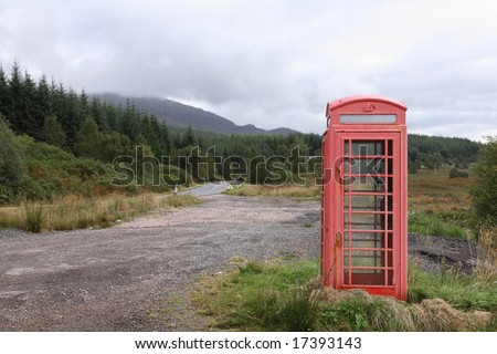 A typical red UK telephone box in a remote location in the Scottish Highlands