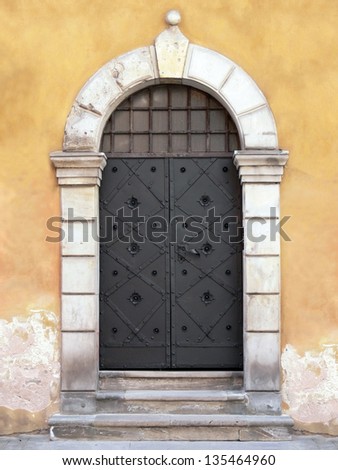 The old iron main door with the stone stairs, Warsaw, Poland