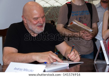 WARSAW, POLAND - MAY 18: Andrzej Mleczko signs his book on the Fourth Book Fair held at the National Stadium on May 18, 2013 in Warsaw