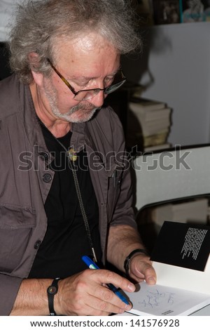 WARSAW, POLAND - MAY 18: Krzysztof Daukszewicz signs his book on the Fourth Book Fair held at the National Stadium on May 18, 2013 in Warsaw