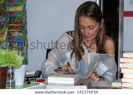 WARSAW, POLAND - MAY 18: Beata Pawlikowska signs her book on the Fourth Book Fair held at the National Stadium on May 18, 2013 in Warsaw
