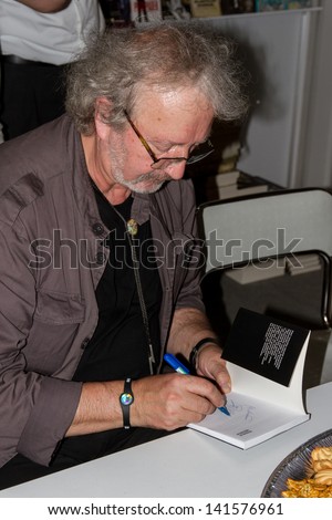 WARSAW, POLAND - MAY 18: Krzysztof Daukszewicz signs his book on the Fourth Book Fair held at the National Stadium on May 18, 2013 in Warsaw