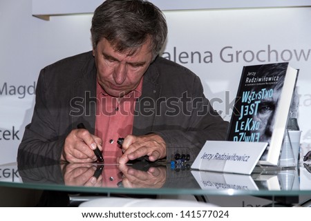 WARSAW, POLAND - MAY 18: Jerzy Radziwi??owicz signs his book on the Fourth Book Fair held at the National Stadium on May 18, 2013 in Warsaw