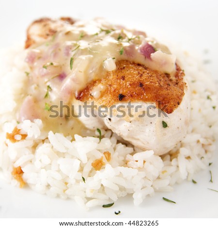 delicious chicken breast fillet with lemon thyme sauce served with garlic rice