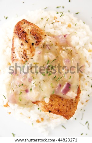 top view of chicken breast fillet with lemon thyme sauce served with garlic rice